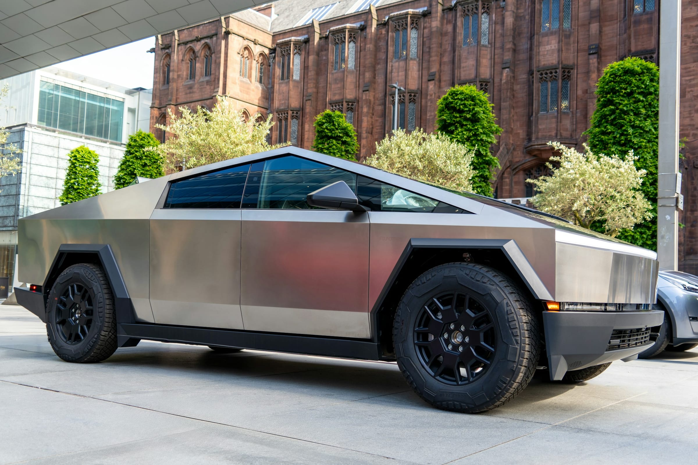 Tesla Cybertruck parked in front of a brick building