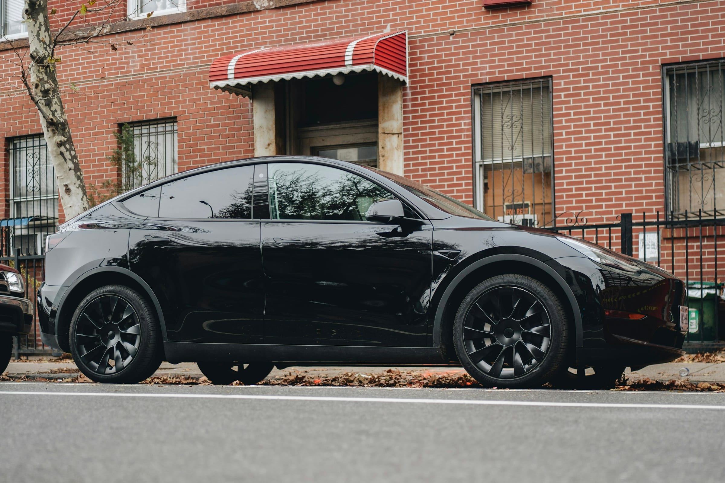 Black Tesla Model Y parked on a city street